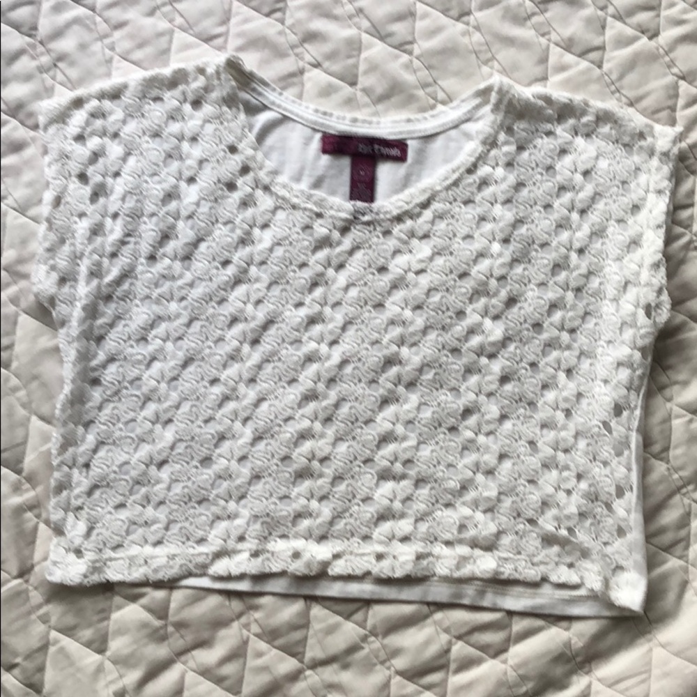Girls white top with embroidered front detail.